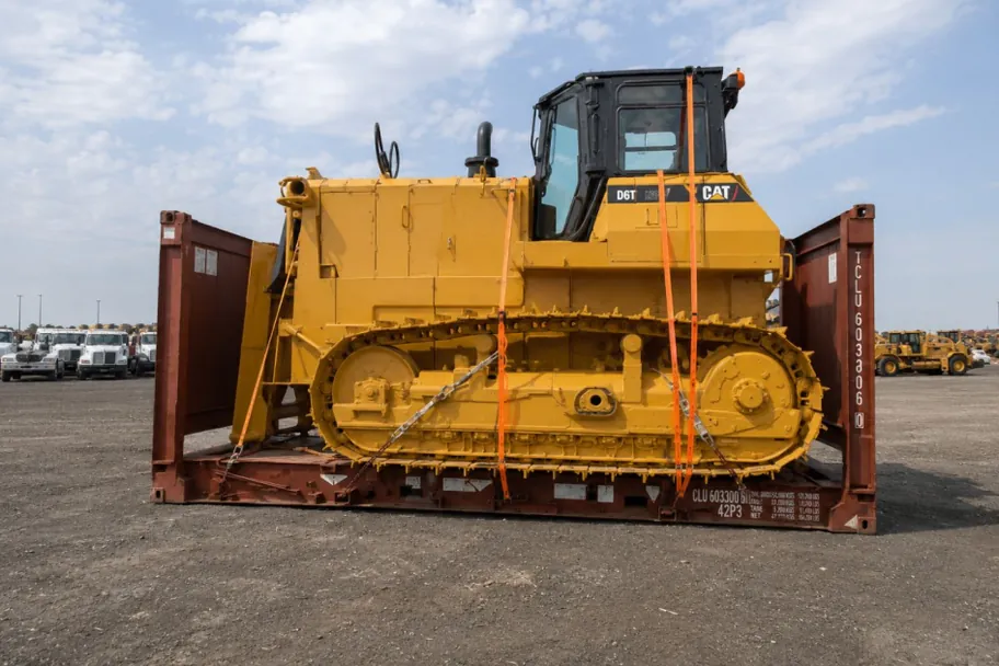Heavy equipment loaded on a 20ft flat rack container