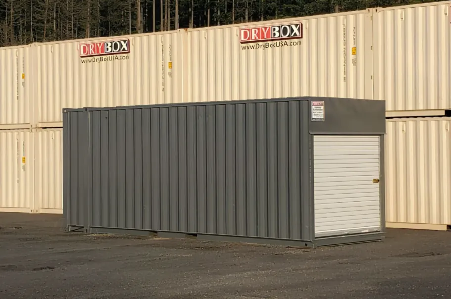 Gray 24ft Dry Box shipping container with a roll-up door in a storage yard