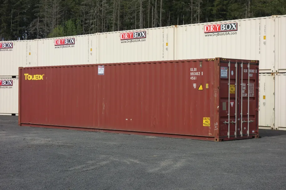 Red 40ft high cube cargo worthy shipping container among stacked Dry Box containers