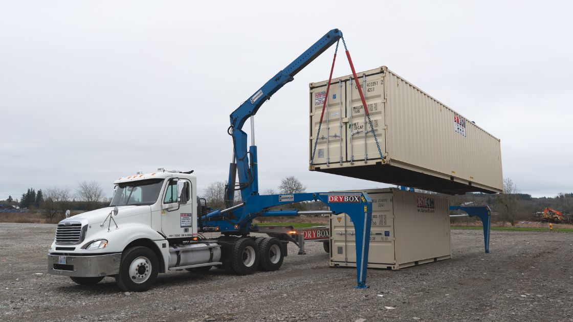 Shipping container side loader delivery truck