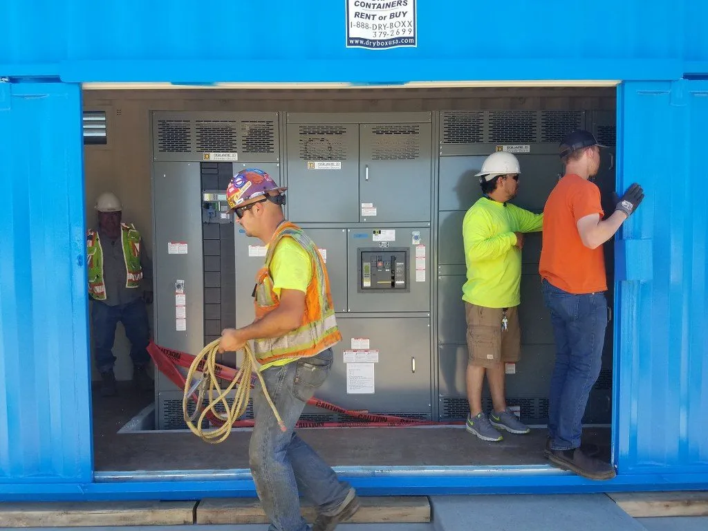 construction workers using dry box shipping containers