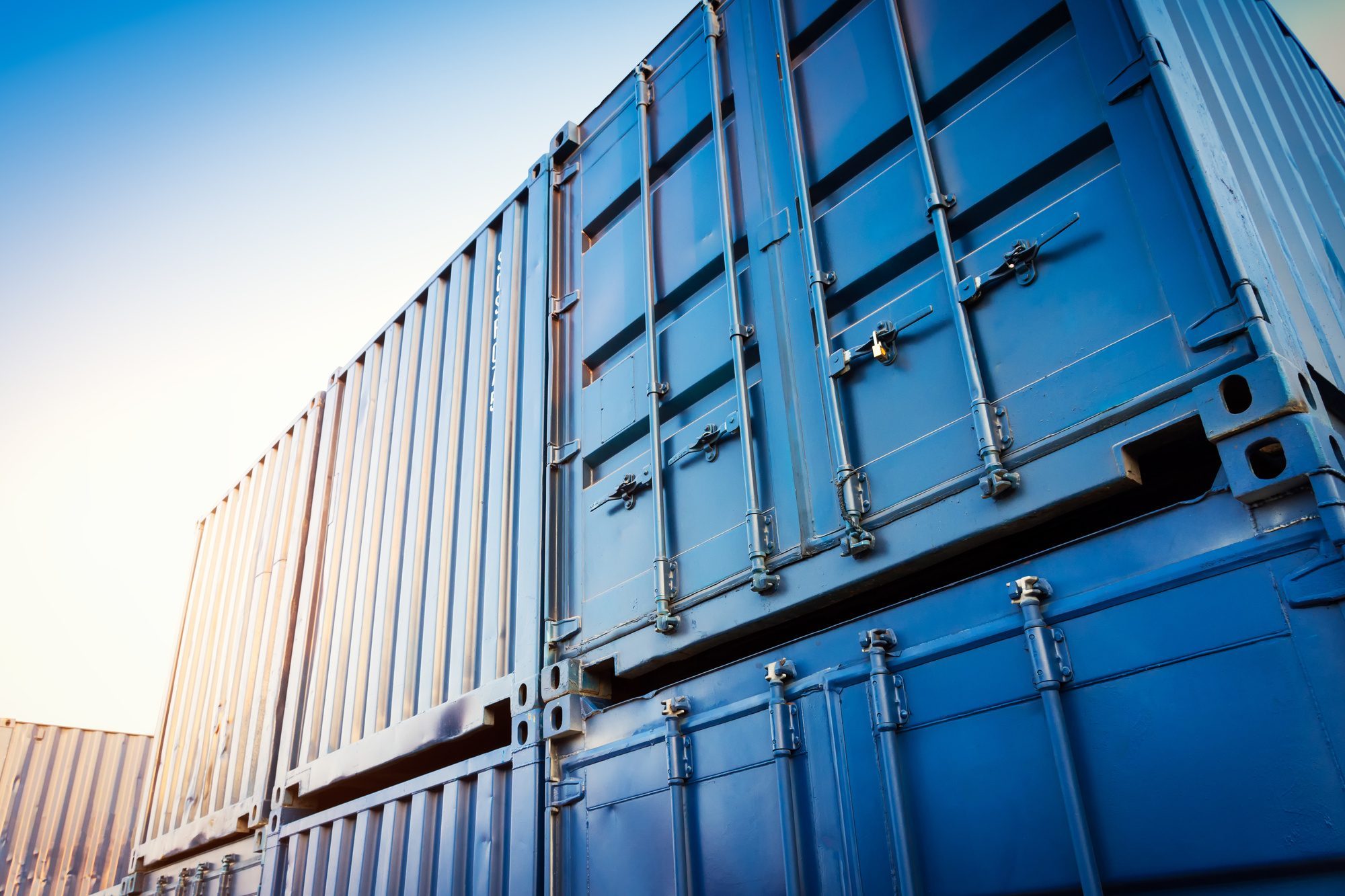 blue shipping containers in industrial yard
