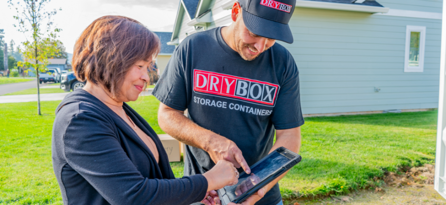 A customer reviews paperwork with a Dry Box driver.
