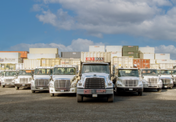 Several Dry Box delivery trucks in v-formation.