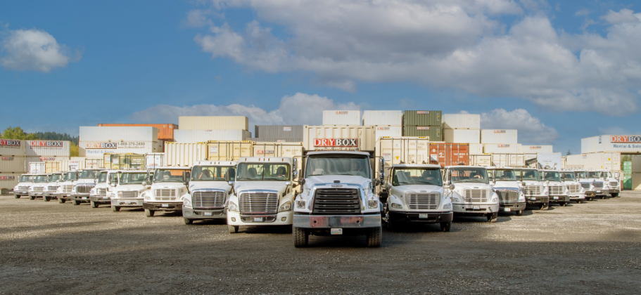 Several Dry Box delivery trucks in v-formation.