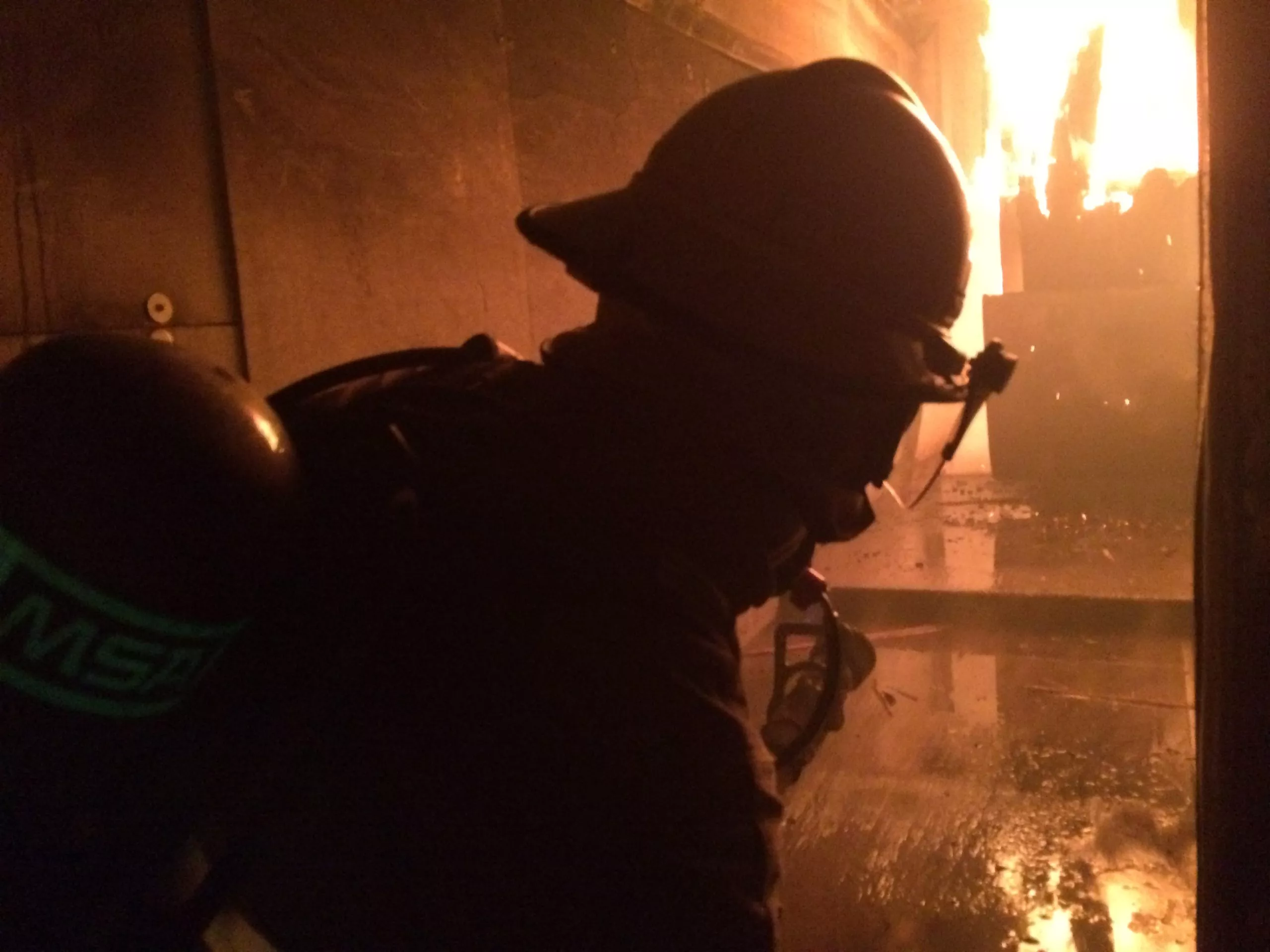 firefighter in front of fire and smoke