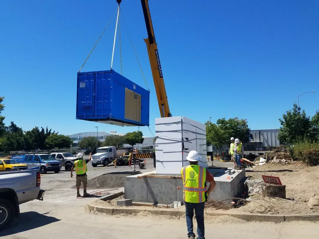 construction workers using dry box shipping containers