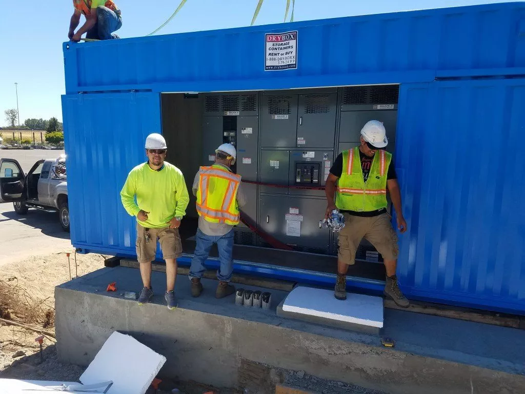 construction workers using dry box shipping containers