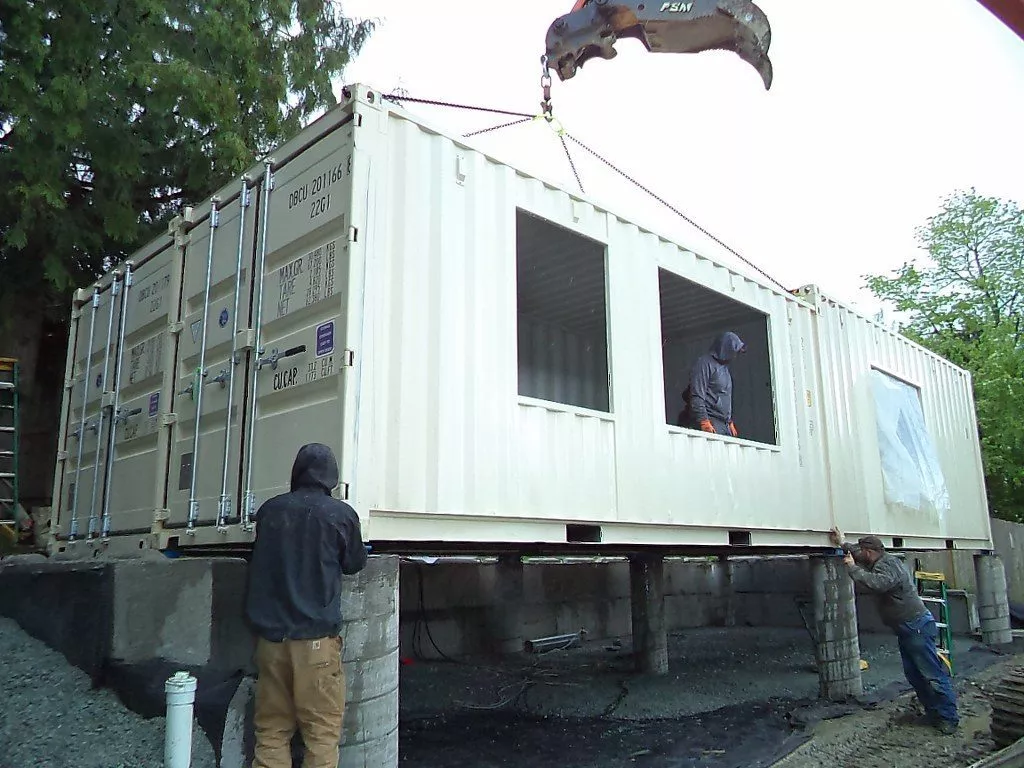 lifting up a white shipping container