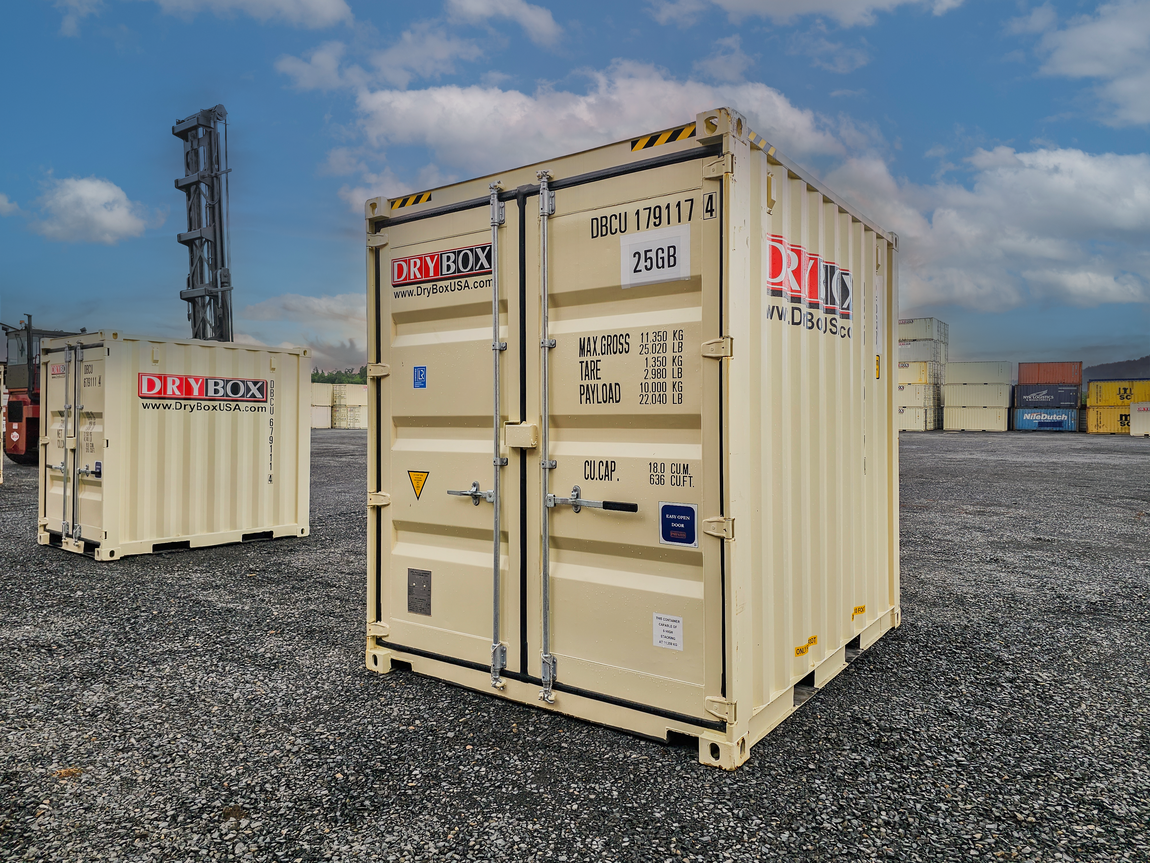 A six-foot wide, beige shipping container, on gravel.