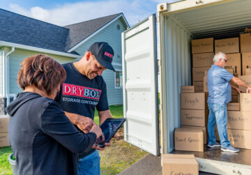 A homeowner signing for their Dry Box delivery.