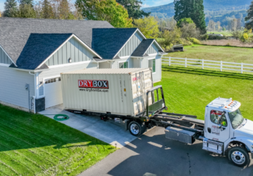 20ft moving container being delivered in a customer's driveway.