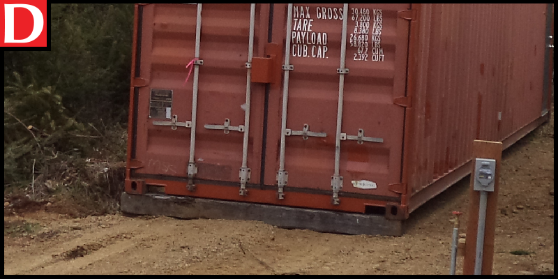 A container sitting on rail road ties